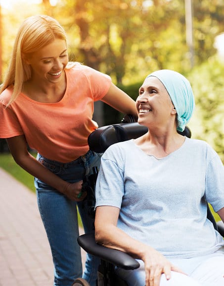 caregiver assiting woman in a wheelchair