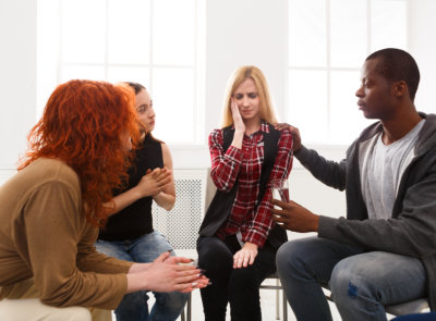 Group of young adult comforting their collegue